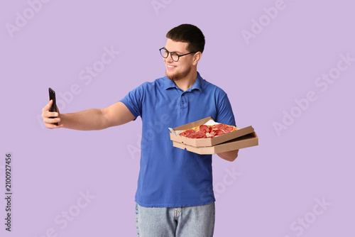 Young man holding cardboard...