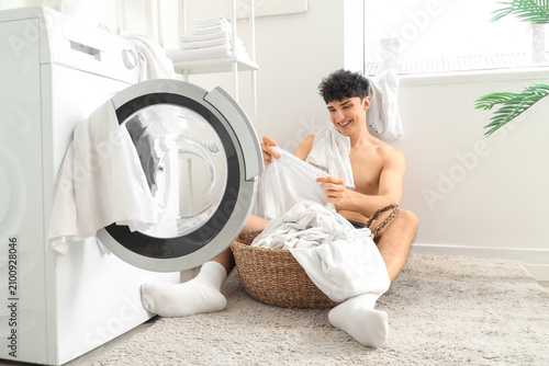 Young man in underpants put...