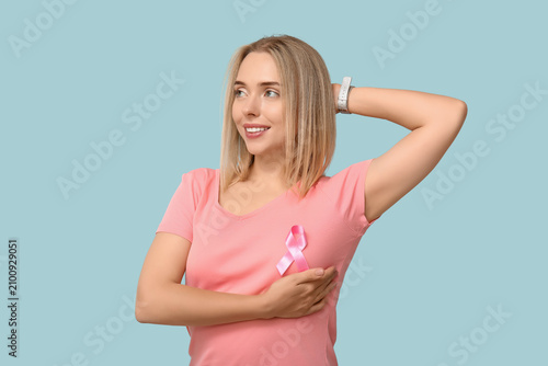 Young woman with pink ribbo...