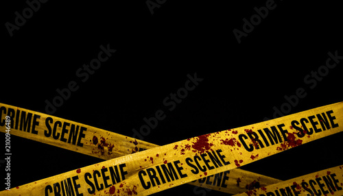 Crime scene yellow tape with blood splatters on black background