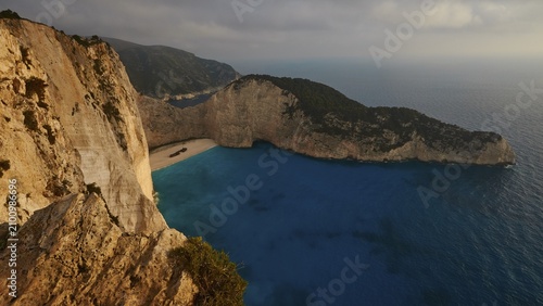 Paralia Navagio, Shipwreck Beach, winter, cloudy sky, deserted beach, rocky cliff, shipwreck MV Panagiotis, blue and turquoise crystal clear sea, Zakynthos, Ionian Islands, Greece