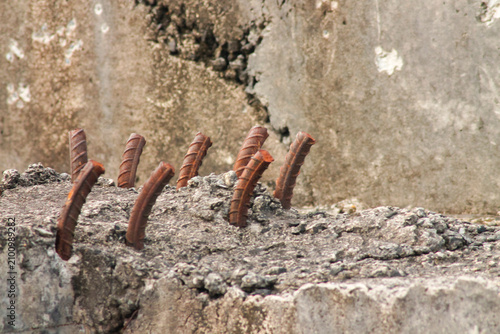 Quadro su tela Close up shot of built-in rusty steel bars, concrete reinforcement mounted in bu