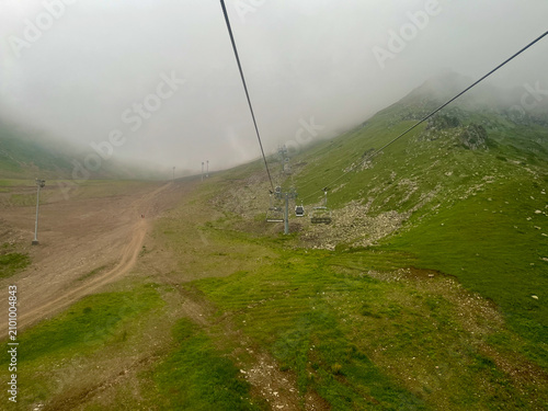 Chairlift disappearing into clouds at Shymbulak Resort in the Trans-Ili Alatau Mountains, Kazakhstan