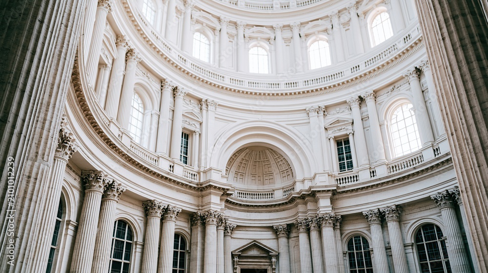 Obraz premium Majestic White Dome Interior Architecture with Classical Columns and Natural Light Streaming Through Windows