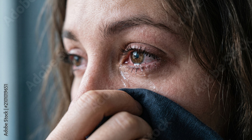 Tearful woman wiping her face with cloth