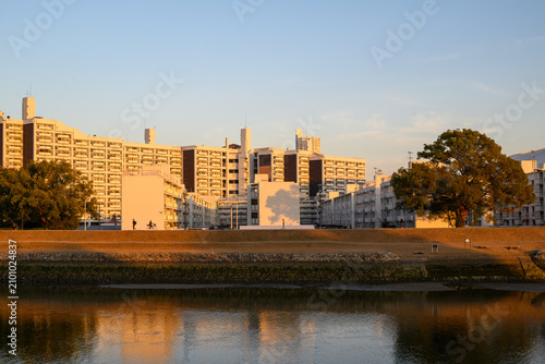Residential apartment complex along a river at sunset