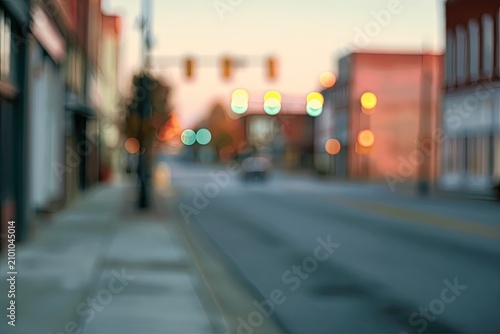 Soft-focus street scene at dusk with blurred traffic lights and buildings