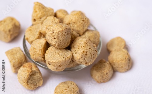 Fotografie Close-up of dehydrated raw soya chunks on glass bowl, vegetarian protein rich, plant based meat substitutes made from defatted soya flour