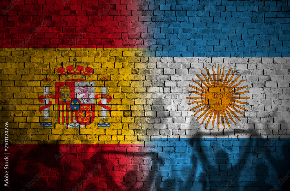 Obraz premium Empty Red Brick Wall with argentina and spain flags