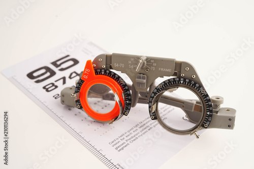 Fotografie Glasses on eye testing exam chart to check eyesight accuracy of reading
