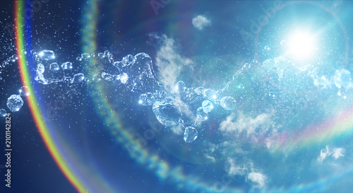 キラキラ飛び散る水滴　水しぶき　爽やかな青空と雲の背景　眩しい太陽の日差しとレンズフレア　夏・夏休み・水遊び・プール・飲料水・猛暑・酷暑・熱中症の背景	