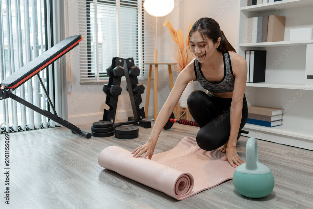 Fototapeta premium A fitness trainer guides a woman through stretching and mobility exercises on a yoga mat, improving flexibility, posture, recovery, and overall physical wellness in a modern fitness studio.