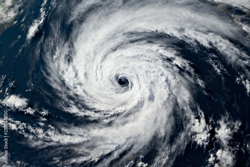 Satellite view of a powerful hurricane with a well-defined eye and spiral cloud patterns over the ocean