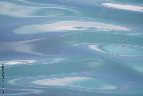 Calming ocean waves, blue water ripples, serene sea surface, abstract aquatic background