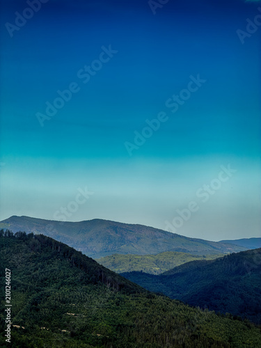 Sunny Carpathian peaks: green valleys and cloudy skies.