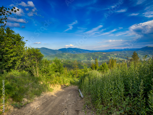 Sunny Carpathian peaks: green valleys and cloudy skies.
