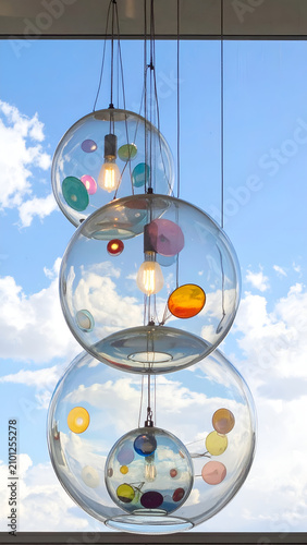 Modern Chandelier with Colorful Glass Orbs Suspended Against Sky.