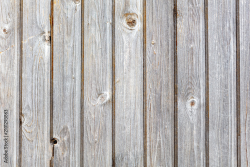 Billede på lærred Weathered wooden planks stand vertically side by side