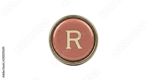 Foto Vintage typewriter key with the letter R on a dusty pink background