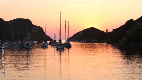 Real time footage of yachts anchored at sunset in Watermouth harbour in North Devon, UK