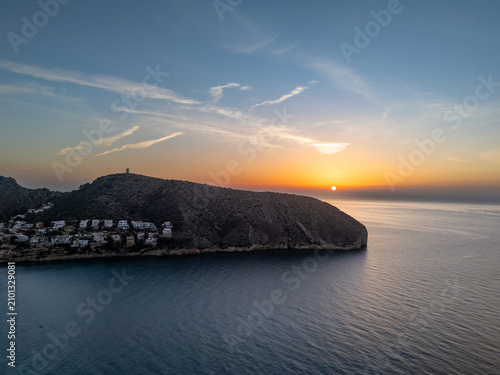 Aerial Sunrise Over Mediterranean Coastal Cliff With Seaside Village And Calm Ocean Horizon, Alicante, Spain