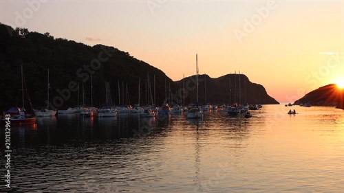 Real time footage of yachts anchored at sunset in Watermouth harbour in North Devon, UK