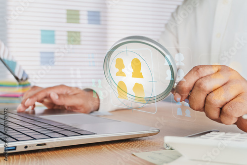 Marketer using laptop and digital virtual interface to analyze customer targeting data insights, Niche marketing and personalization concept, Marketing segmentation strategy and consumer analysis