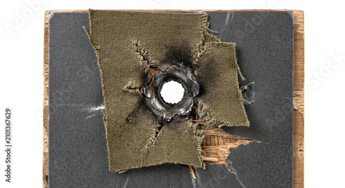 Fotografie Bullet hole in ballistic fabric and composite material showing damage and impact