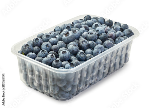 Ripe blueberries in a plastic container on a white background. Isolated