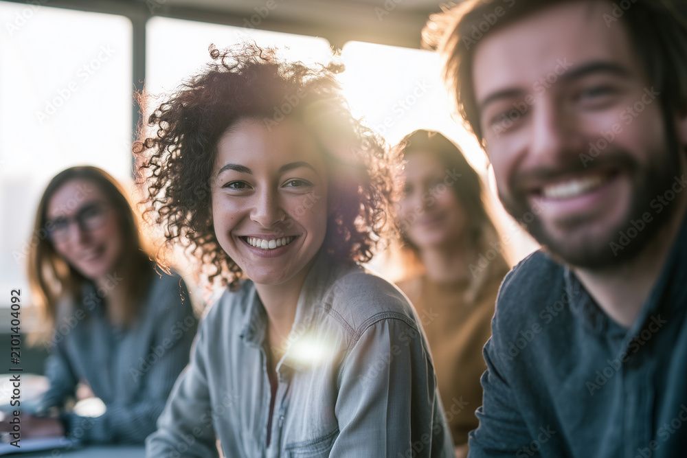 Obraz premium Group of four smiling people in business attire indoors in daylight