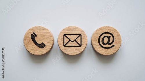 Wooden circles with icons for phone, mail, and email contact isolated on white background