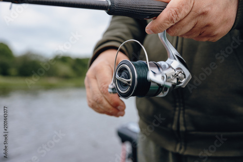 A spinning rod with a spinning reel in the hands of a fisherman