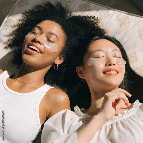 Two Women Relaxing with Under Eye Patches During Skincare Routine