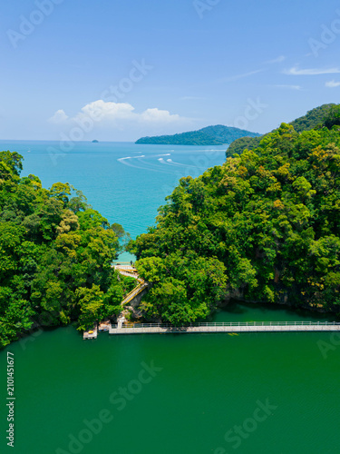 Canvastavla defaultAerial drone view of calm green lake bordering with blue sea scenery at Dayang Bunting Lake in Langkawi Island, Kedah, Malaysia