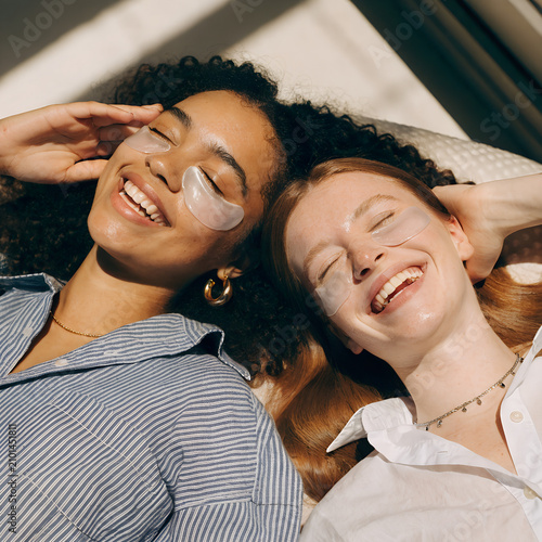 Two Women Relaxing with Under Eye Patches During Skincare Routine
