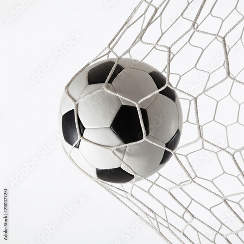 Soccer ball in net, close up, isolated on white background, symbolizing a goal scored and sports achievement.