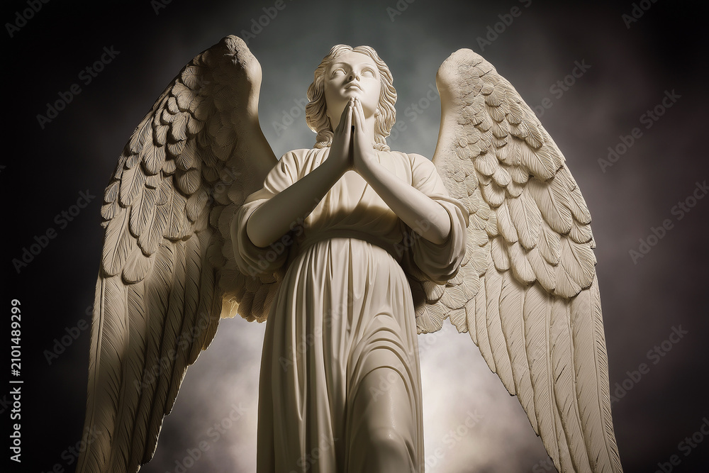 Fototapeta premium A marble angel statue stands with hands clasped in prayer beneath a moody sky. Spiritual guardian of faith, devotion, hope, protection, memorial, serenity and religious art. Funeral, burial.