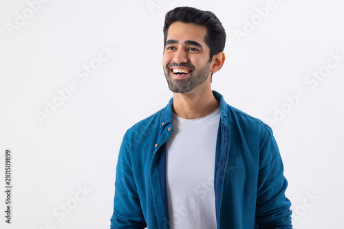 Portrait of happy young man looking elsewhere and laughing
