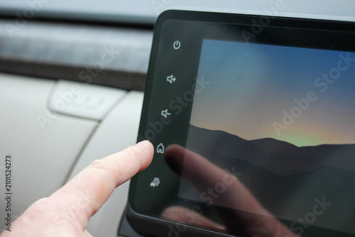 Man using a digital media system in a new vehicle