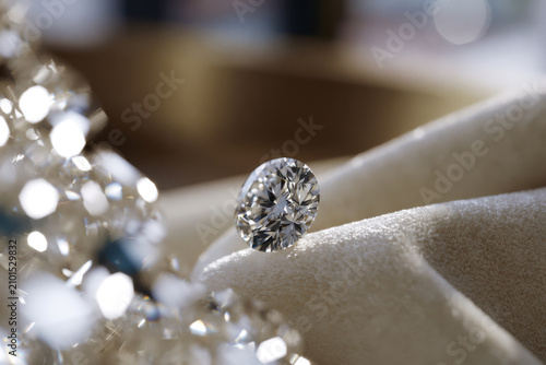 A beautifully captured close-up of a sparkling diamond set against a soft fabric background, highlighting its clarity and captivating sparkle, representing luxury and beauty.