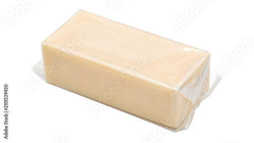 Block of butter isolated on white. Dairy product in plastic packaging for cooking and baking.