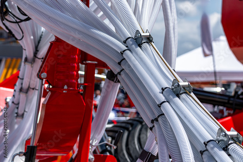 Fotografie Agricultural seeder pneumatic seed distribution hoses on farm machine