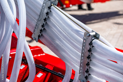 фотографія Agricultural seeder pneumatic seed distribution hoses on farm machine