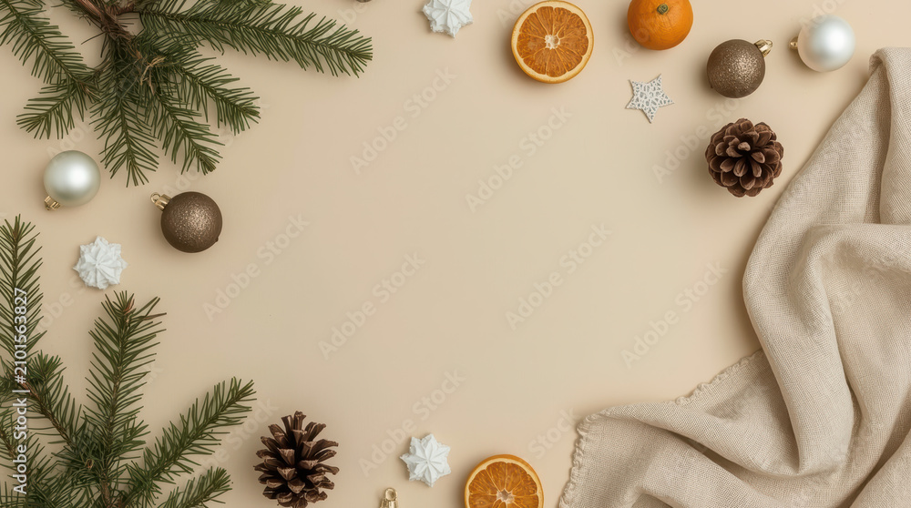 Fototapeta premium Minimal Christmas flat lay with evergreen branch, pinecone, dried orange, ornaments evoking cozy
