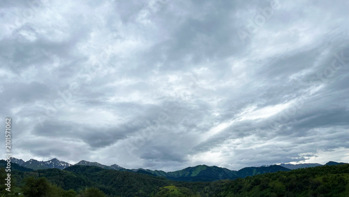 Cuadro en lienzo Panoramic view of green mountains under dramatic cloudy skies in Kazakhstan