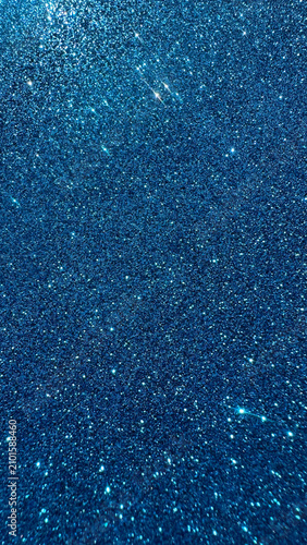 Dark blue glitter texture with sparkling light reflections