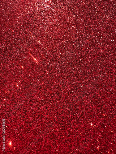 Deep red glitter texture with reflective sparkle particles