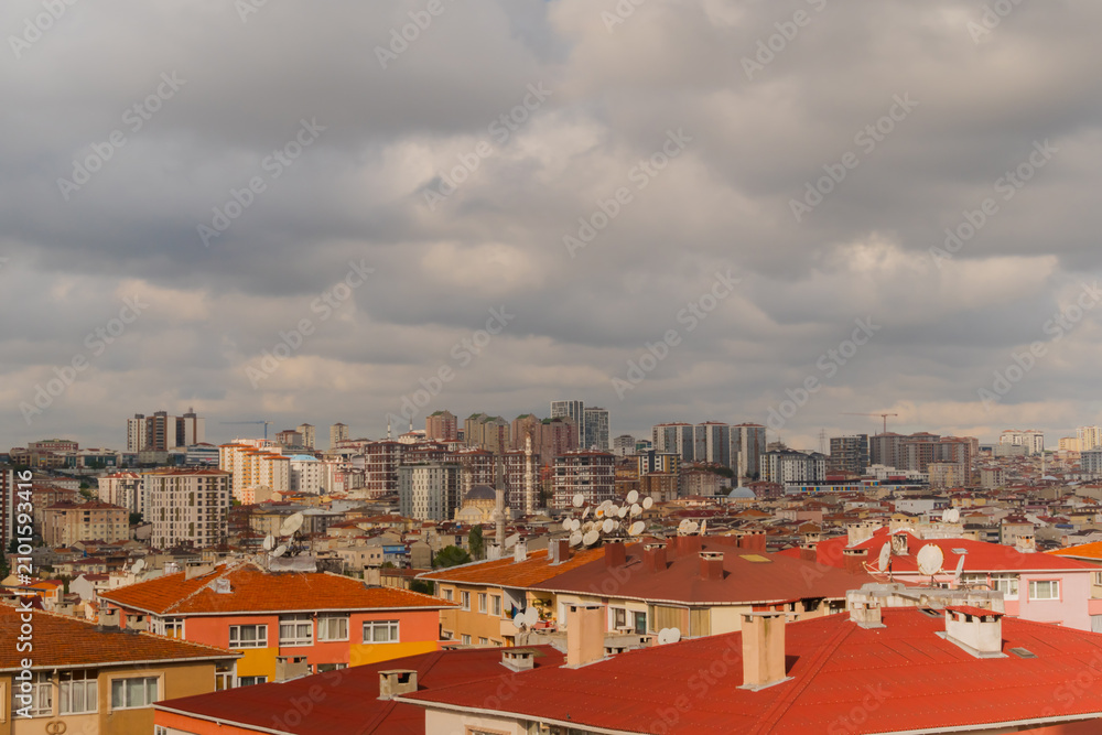 Obraz premium View of gray clouds in the cloudy sky over typical turkish apartment, residential buildings in Istanbul - afternoon, daylight. Architecture and cityscape concept