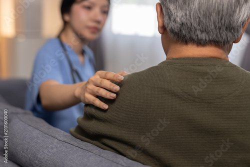 Fotografie Caring female nurse providing comfort to senior man patient showing empathy and