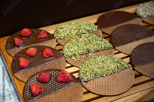Close-up of stroopwafels displayed in a pastry shop window in the Netherlands